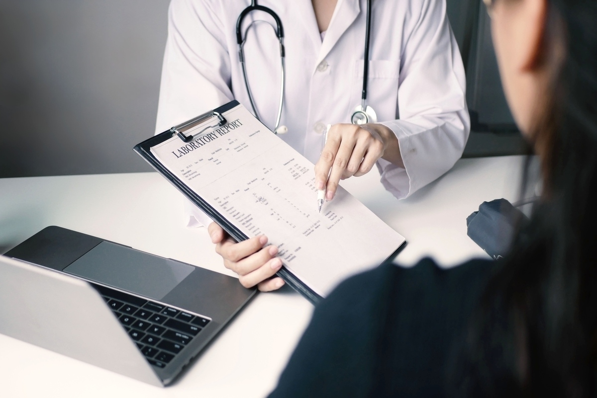 Doctor reviewing laboratory report with patient representing personalized medical weight loss program evaluation