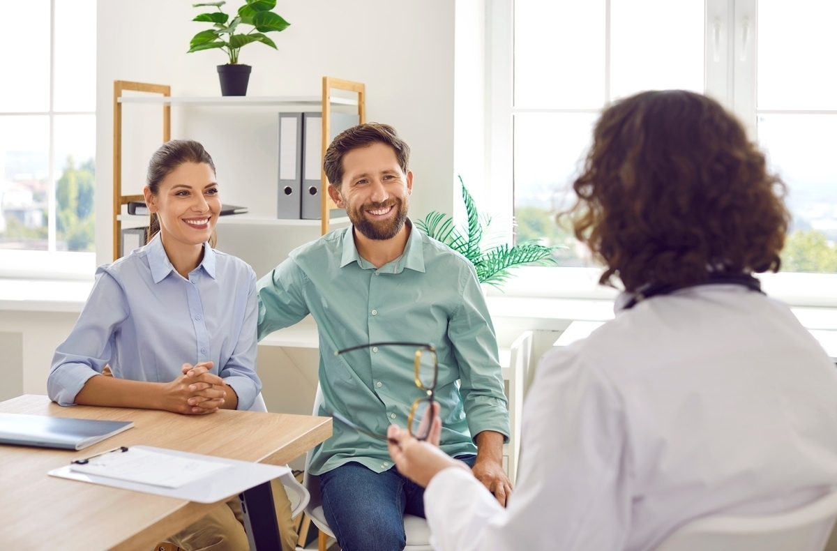Couple consulting a doctor about TRT and fertility implications before starting testosterone replacement therapy